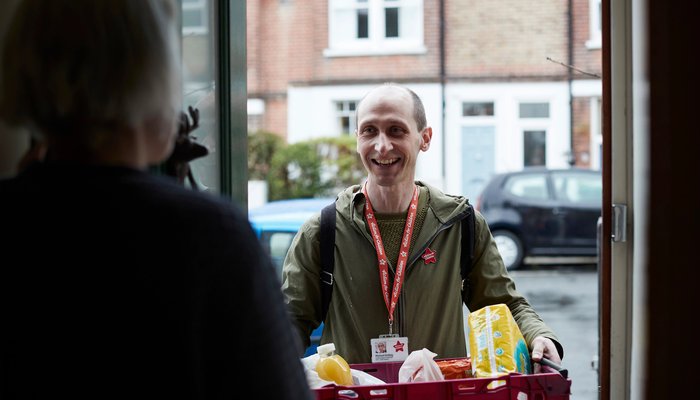 Action for Children worker delivering grocery items to a house