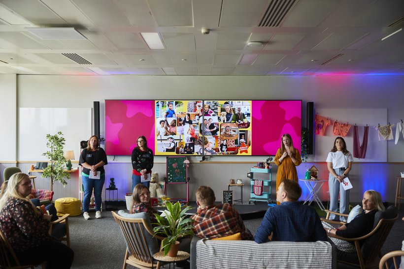 Action for Children workers talking about Nationwide Fairer Futures in a room