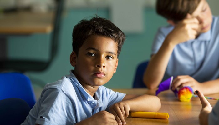 Boy in uniform neutral expression