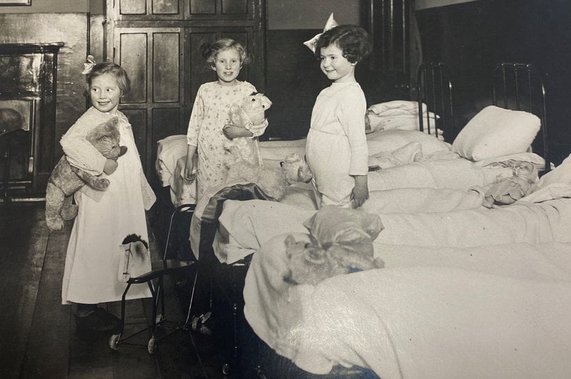 Black and white image of three girls dressed for bed