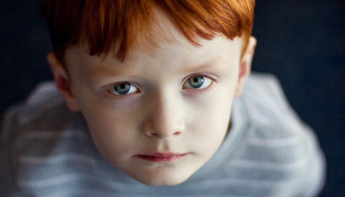 boy staring up at camera