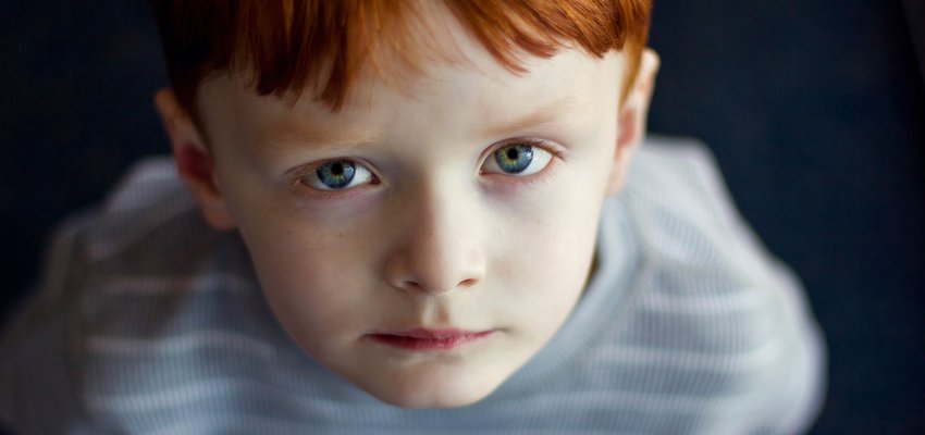boy staring up at camera