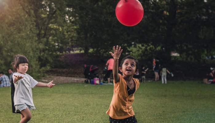 children playing with red balloon