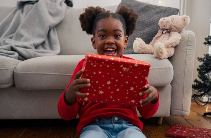 Chloe holding a present and smiling