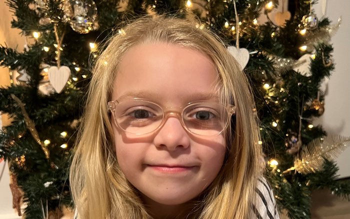 Darcy simling into camera up close