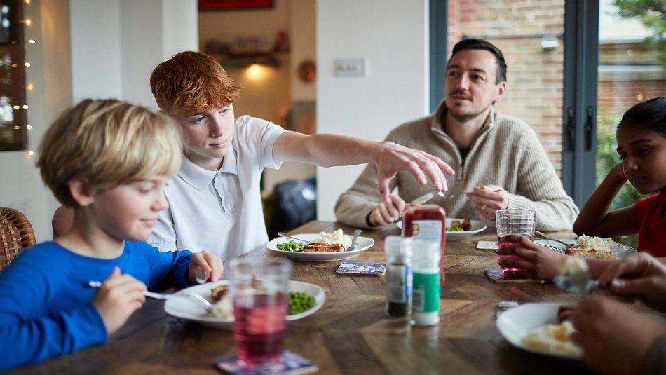 Family gathered around table having lunch