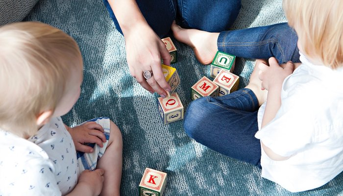 Family playing with letter blocks