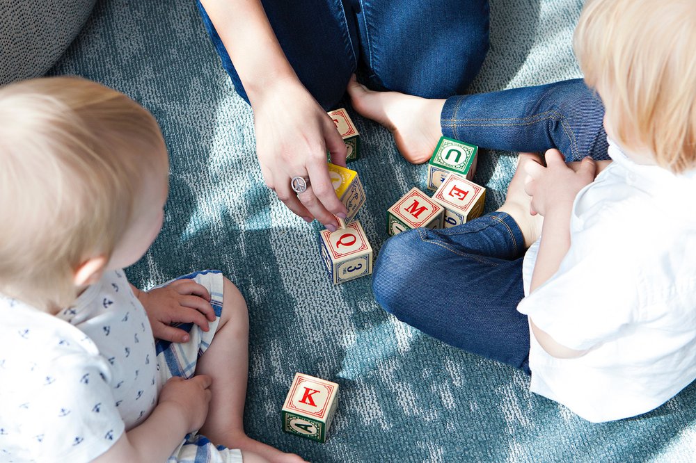 Family playing with letter blocks