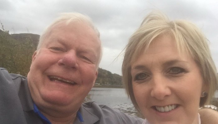 Foster carers Jim and Donna taking a selfie on a boat on a cloidy day
