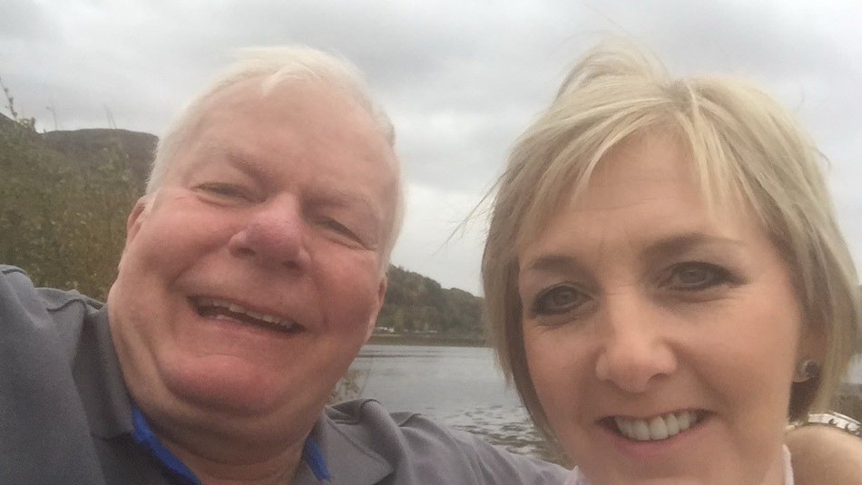 Foster carers Jim and Donna taking a selfie on a boat on a cloidy day