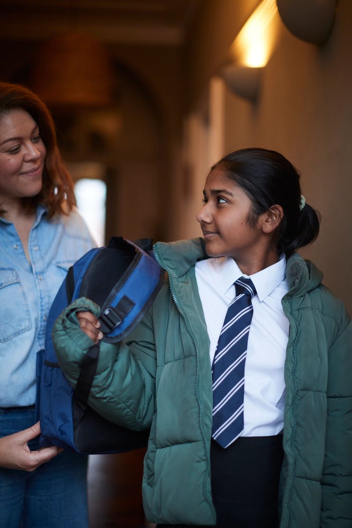 Girl gets ready to leave for school with her carer