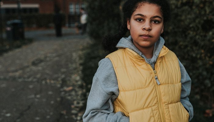 Girl in outside looking straight ahead at camera