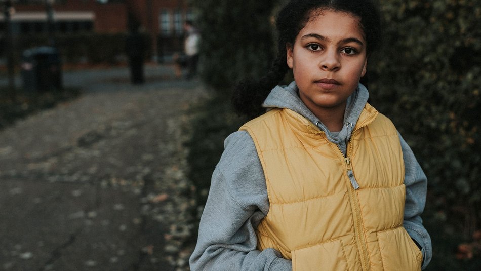 Girl in outside looking straight ahead at camera