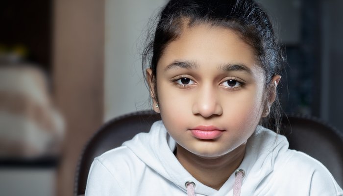 Girl looking at the camera with a blank expression