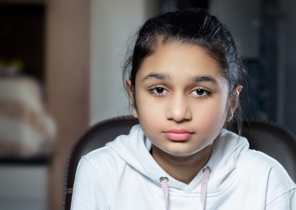 Girl looking at the camera with a blank expression