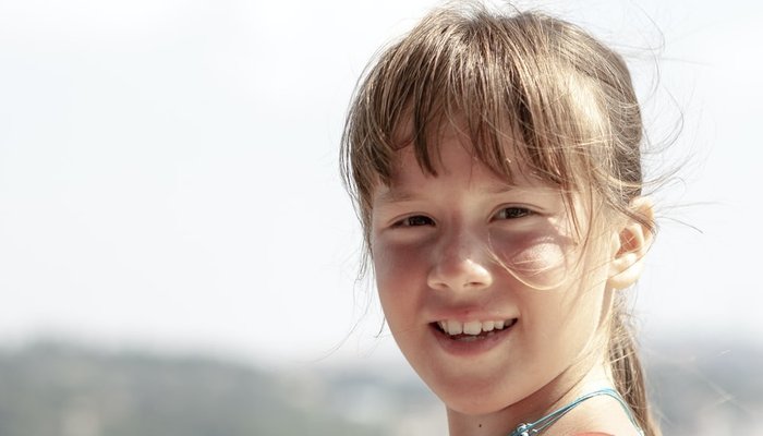 Girl standing in the sunshine