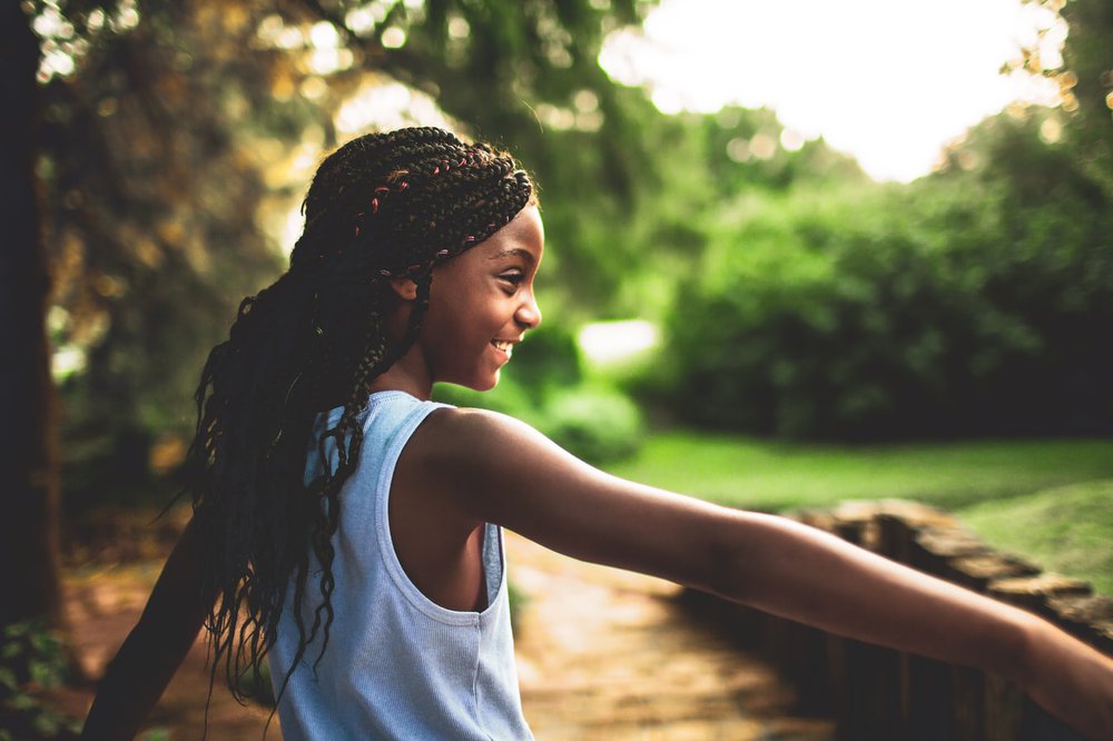 Girl with long hair standing outside in the garden