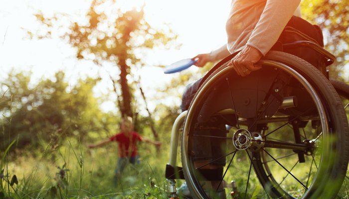 Grandmother in wheelchair throwing frisby to Grandson in the park.jpg