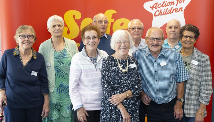 Group of old boys and girls standing together smiling and looking at camera