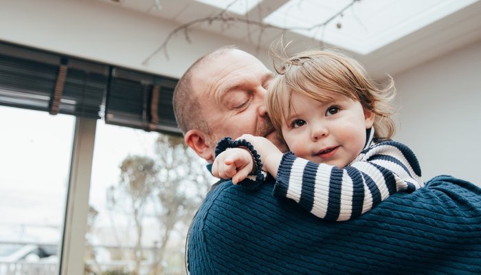 Happy father holding daughter