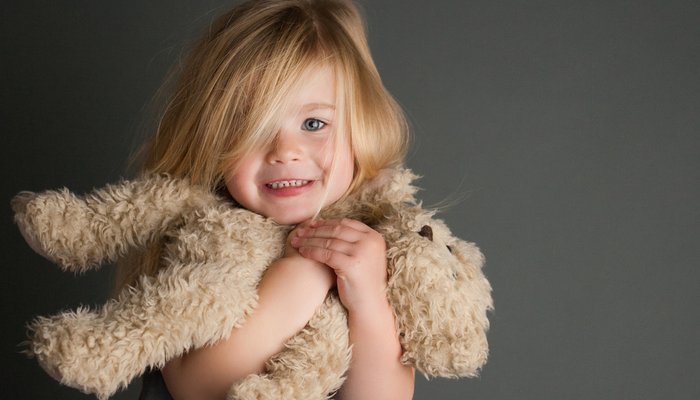 Happy girl with teddy bear