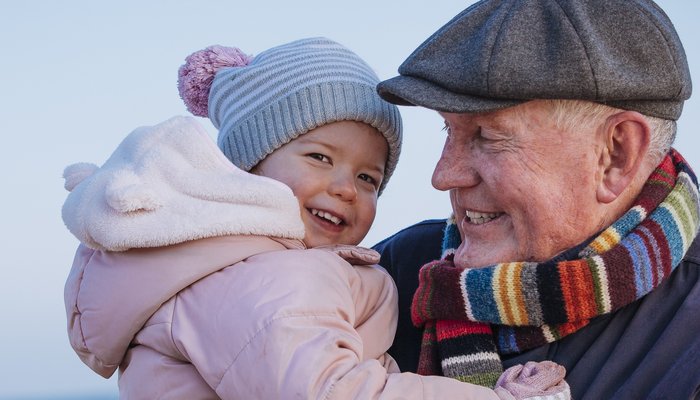 Happy grandpa holding grandaugther