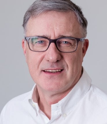 Headshot of Paul Carberry CEO of Action for Children wearing glasses