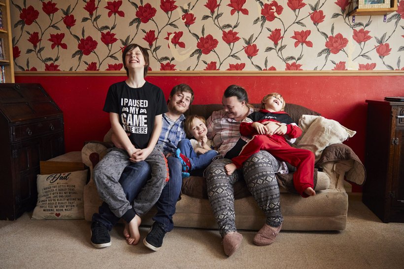 Jacob sitting on the sofa with all of his family