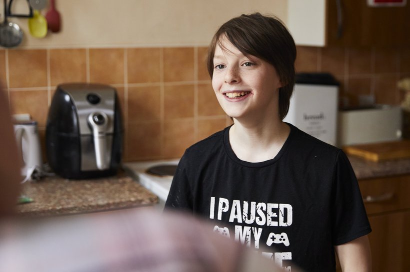 Jacob standing in kitchen smiling