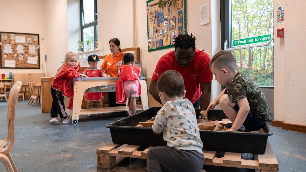 Jerome playing with children at nursery