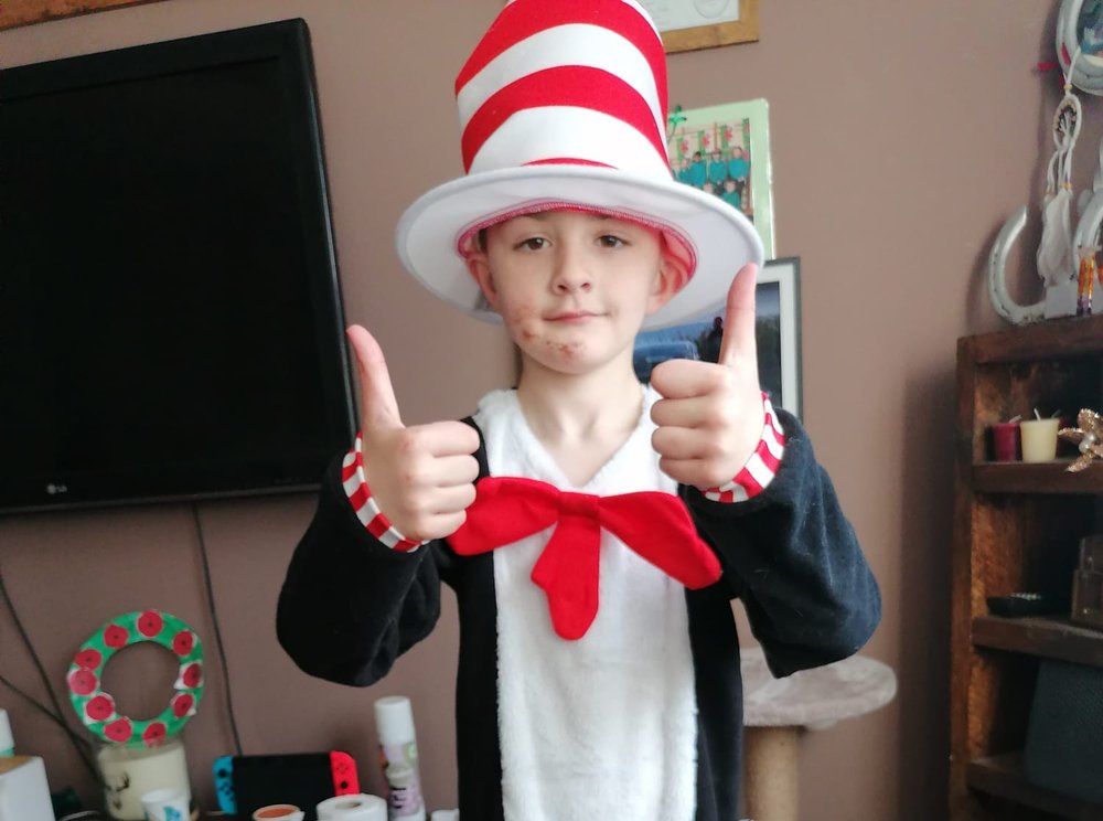 Joel wearing a Cat in the Hat costume. He is giving a thumbs up to the camera.