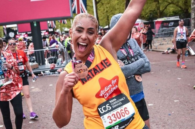Action for Children runner called Natalie smiling with medal at the end of the London Marathon