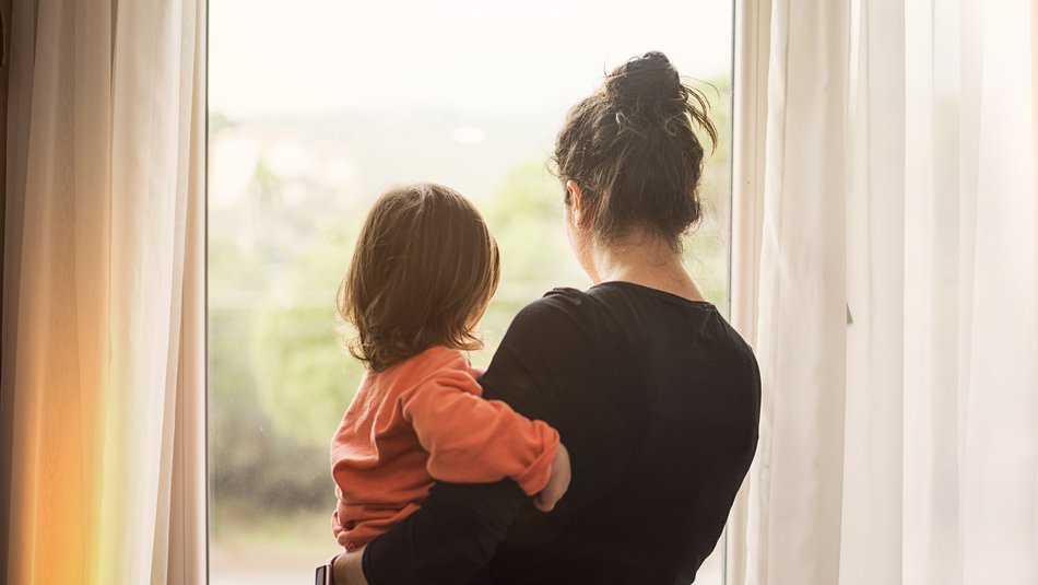 mother holding child looking out of window.jpg