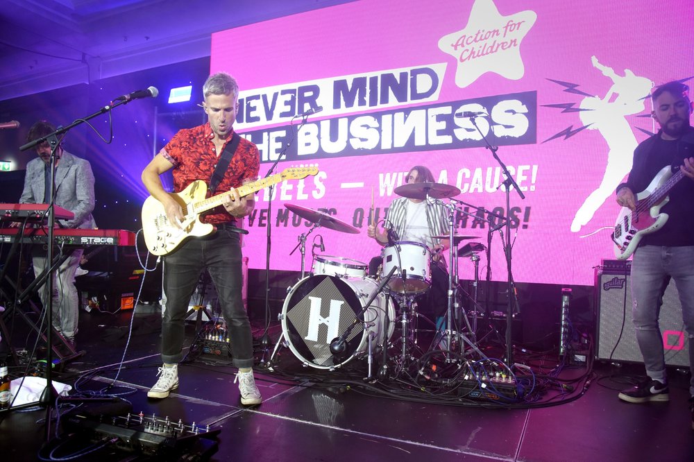 Hoosiers performing on stage at the Never Mind the Business event