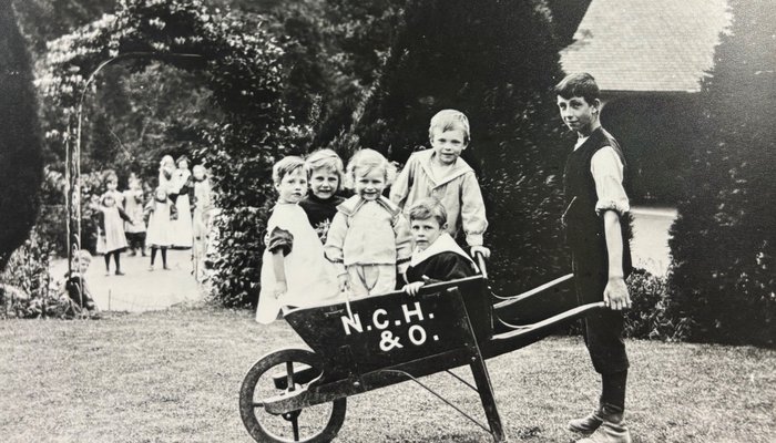 Children in wheelbarrow at NCH home in Chipping Norton 1909