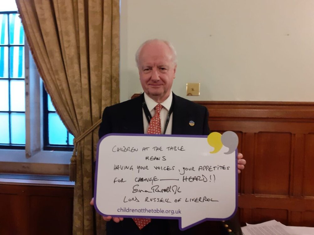 Parliamentarian and pledge at children at the table