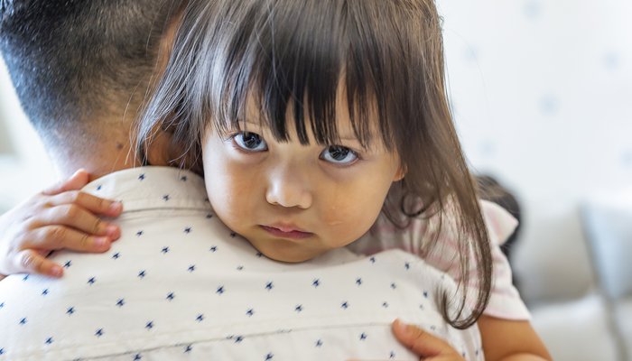 Sad daughter being comforted by her dad