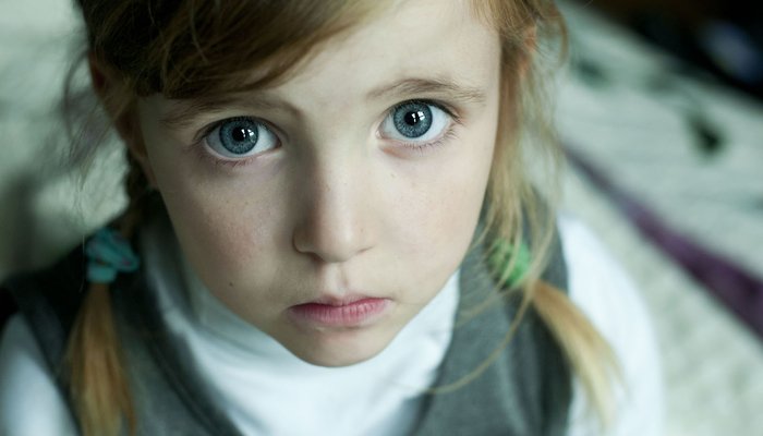 Sad young girl looking up