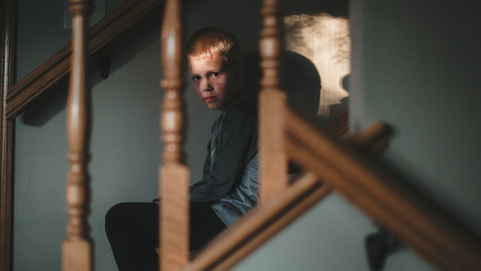 Scared boy on staircase
