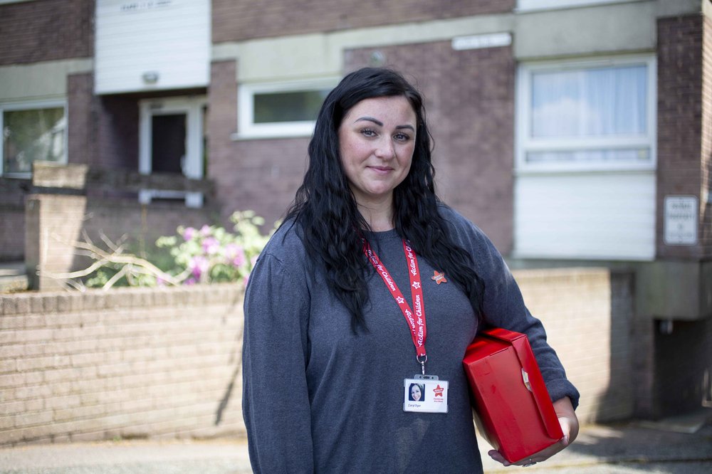 Action for children support worker holding shoe box