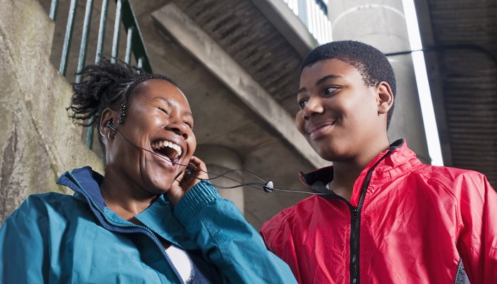 Teenage boy with mother on headphones