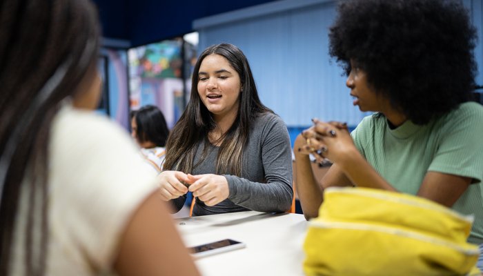 Teenagers in a classroom having a disucssion