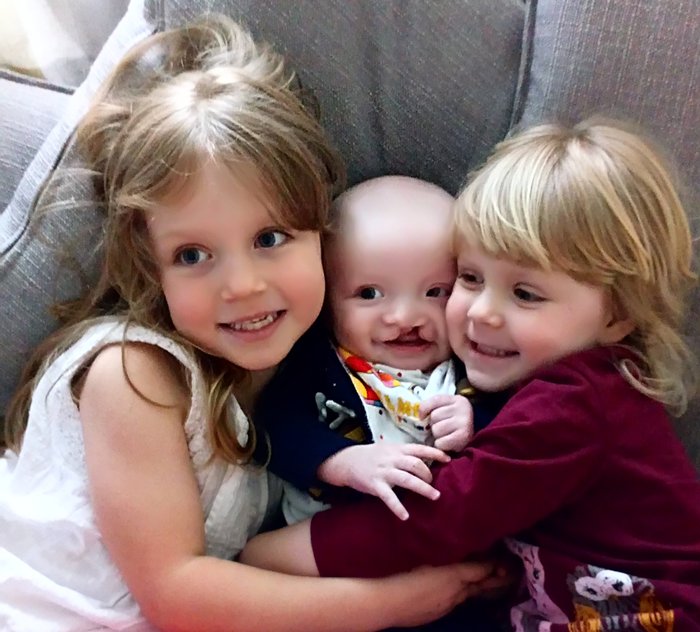 Thomas cuddling his sisters