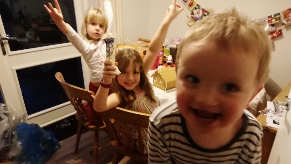 Thomas with his two older sisters at Christmas