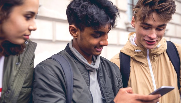 Three teenager looking at phone