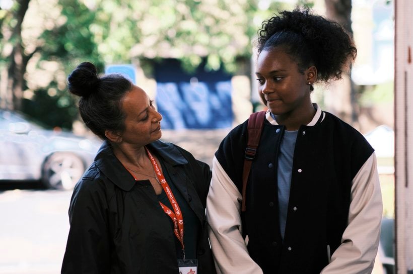 Young Ambassador Chan walking with Action for Children staff member