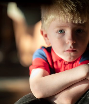 Young boy crossing arms