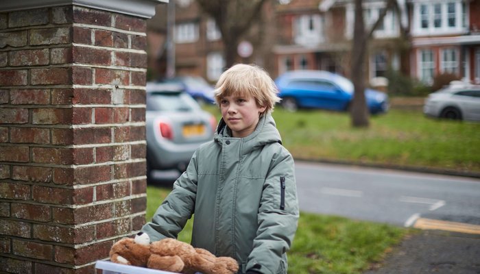 Young boy moving into care home with teddy