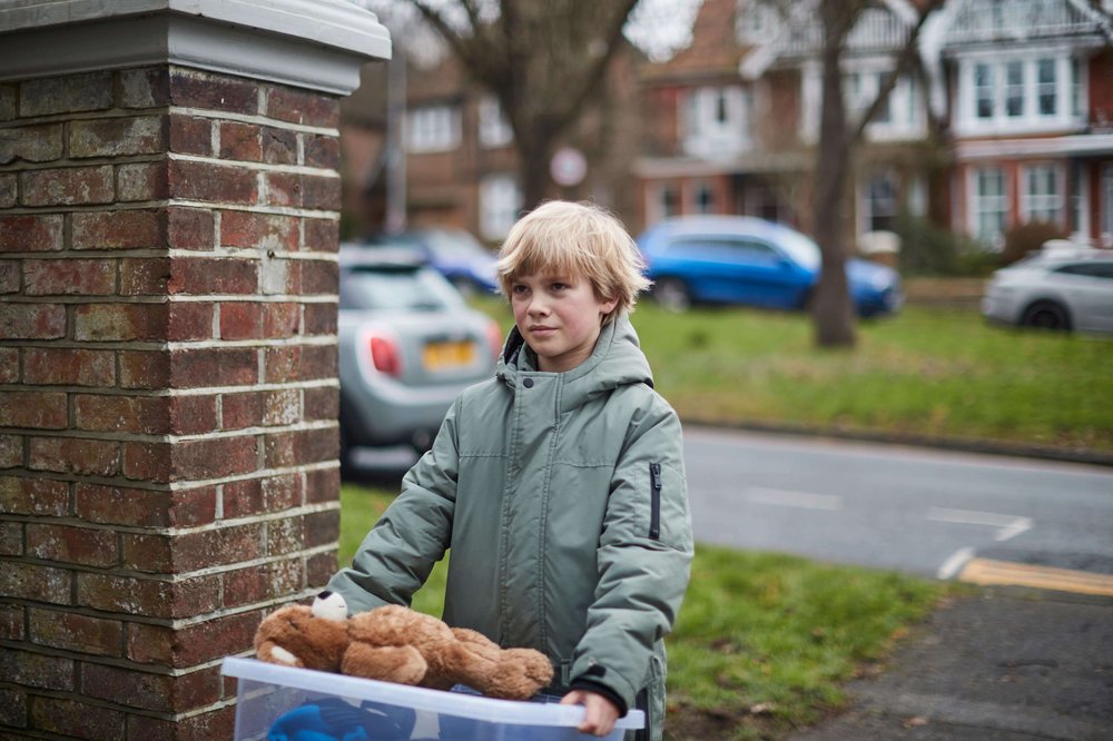 Young boy moving into care home with teddy