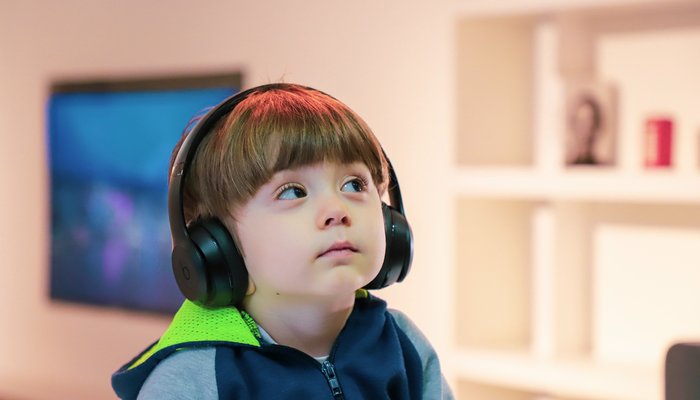 Young boy wearing large headphones